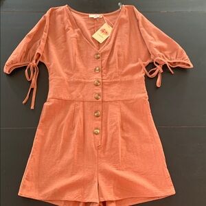 Entro Terracotta V-Neck Romper with cream/brown buttons.